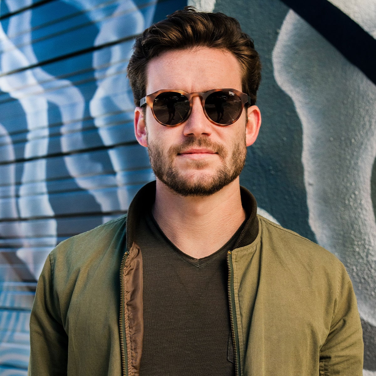 front view of bearded man wearing distil cooper sunglasses with tortoise frames and polarized lens